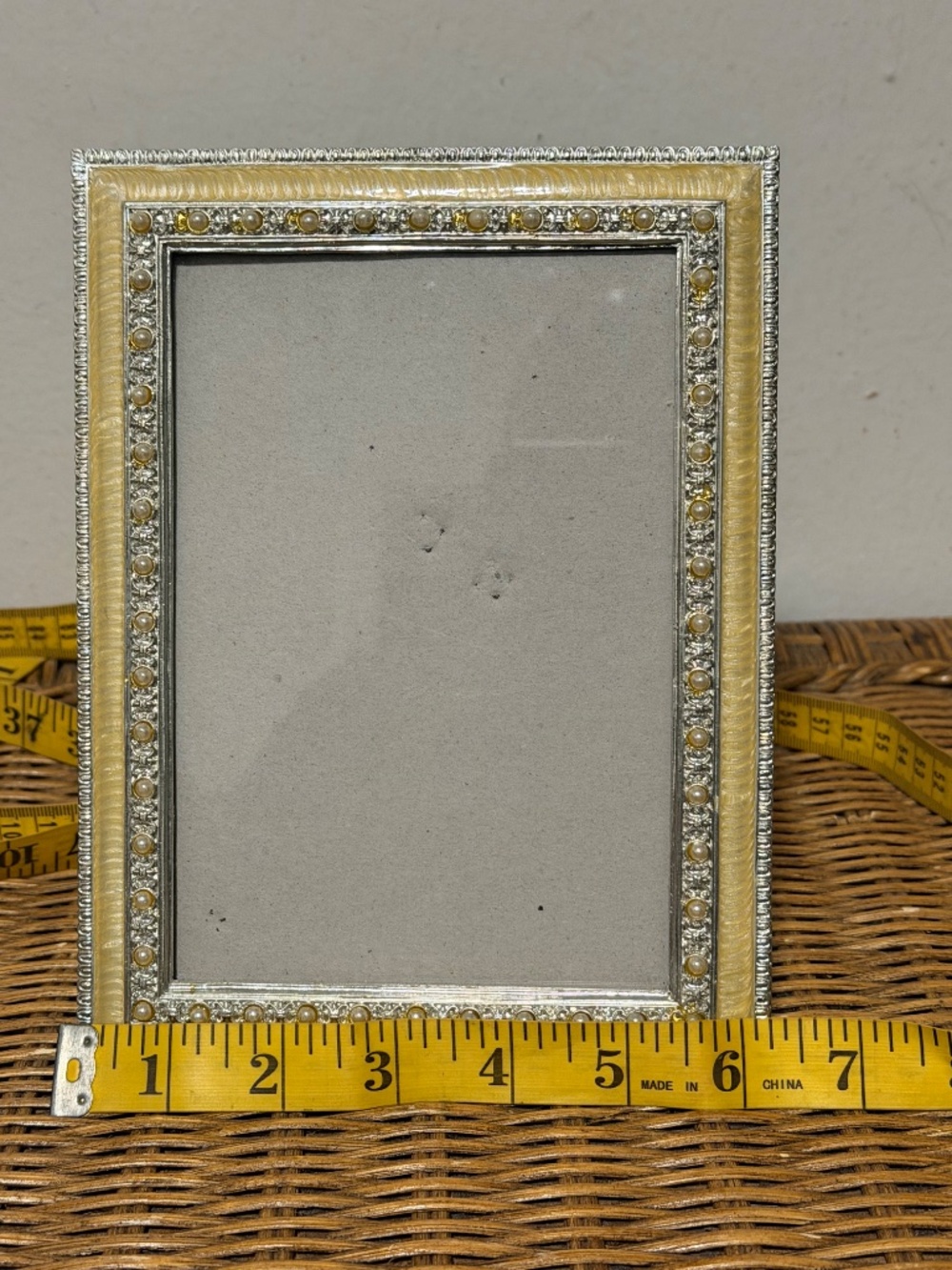 Rectangular tabletop picture frame featuring a yellow/gold-tone enameled border